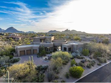 Luxury home with desert landscape, expansive views, and a three-car garage at 11077 E Cinder Cone Trl, Scottsdale, AZ 85262