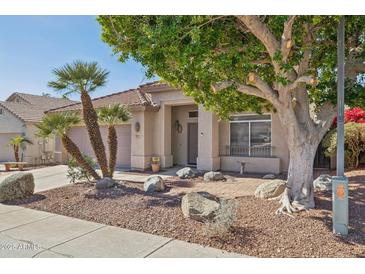 Charming home exterior features desert landscaping, a tile roof, and a welcoming covered front porch at 13248 N 12Th Pl, Phoenix, AZ 85022