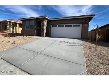 Single-story home with attached garage and desert landscaping at 17299 W Desert Sage Dr, Goodyear, AZ 85338