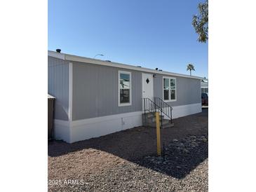 Gray single-wide manufactured home with a small yard at 320 E Mckellips Rd # 50, Mesa, AZ 85201