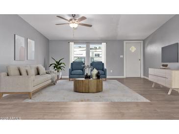 Bright living room features modern furniture, neutral color palette, and lots of natural light at 320 E Mckellips Rd # 50, Mesa, AZ 85201