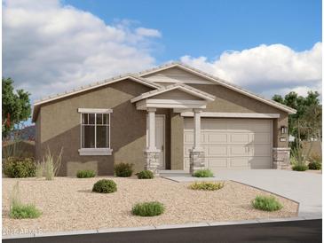 Single-story home with tan exterior, stone accents, and two-car garage at 32693 N Newby Dr, San Tan Valley, AZ 85143