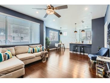 Open-concept living room featuring modern finishes, hardwood floors, and lots of natural light at 3302 N 7Th St # 249, Phoenix, AZ 85014