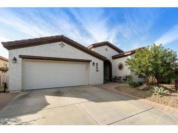 A charming home featuring a well-manicured lawn, a two-car garage, and an inviting front entrance at 4439 E Ficus Way, Gilbert, AZ 85298