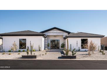 Stunning modern home with desert landscaping and a paved walkway at 7130 E Saddleback St # 11, Mesa, AZ 85207