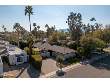 Aerial view of single-story home with landscaped yard and pool; located in a quiet residential neighborhood at 7605 E Via De Lindo --, Scottsdale, AZ 85258