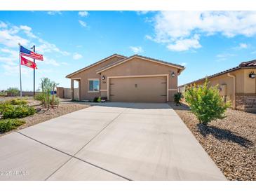 Single-story home with two-car garage and desert landscaping at 961 W 20 Th St, Florence, AZ 85132