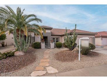 Single-story home with desert landscaping and a stone walkway at 16019 W Kino Dr, Surprise, AZ 85374