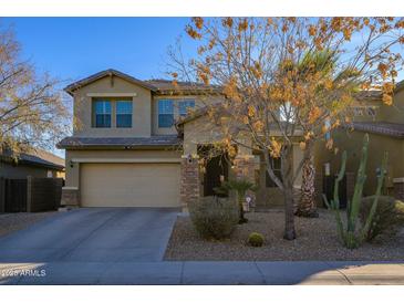 Two story home featuring a desert landscape, and a two car garage at 17965 W Carol Ave, Waddell, AZ 85355