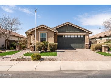 Charming single-story home featuring a well-manicured front yard and a two-car garage at 18716 N Jameson Dr, Maricopa, AZ 85138