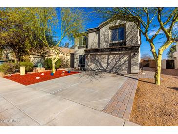 Two-story house with a two-car garage and red rock landscaping at 18907 N Vemto St, Maricopa, AZ 85138
