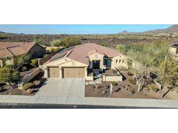 Charming single-story home with a desert landscape, a tile roof, and a two car garage at 30696 N 130Th Ln, Peoria, AZ 85383