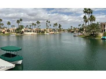 Stunning canal-front property with lush landscaping and boat access at 10120 E Topaz Dr, Scottsdale, AZ 85258