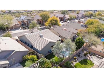 A stunning aerial view shows a beautiful desert home with mature landscaping and a private pool in a serene neighborhood at 10564 E Tierra Buena Ln, Scottsdale, AZ 85255