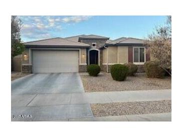 Charming single-story home features a two-car garage and well-maintained landscaping at 15704 W Taylor St, Goodyear, AZ 85338