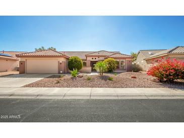 One-story house with desert landscaping and a two-car garage at 16331 W Willow Creek Ln, Surprise, AZ 85374