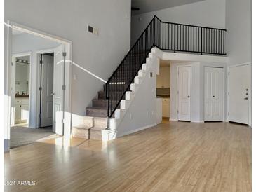 Bright living room with hardwood floors and loft-style stairs at 1701 E Colter St # 421, Phoenix, AZ 85016