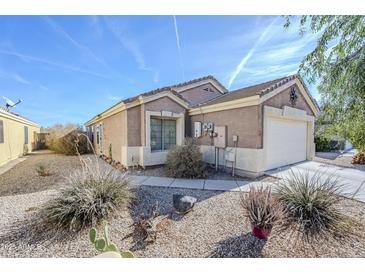 Charming house with a well-manicured front yard and a two-car garage at 24191 N Desert Dr, Florence, AZ 85132