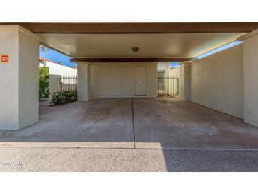 Covered carport with concrete flooring and access to the unit at 2571 N Miller Rd, Scottsdale, AZ 85257