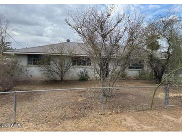 Ranch style home with mature trees and a fenced yard at 2613 E Lynne Ln, Phoenix, AZ 85042