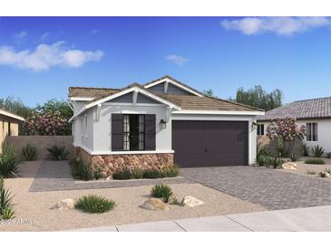 Craftsman style home with dark brown garage door, stone accents, and landscaping at 4388 N 203Rd Dr, Buckeye, AZ 85396