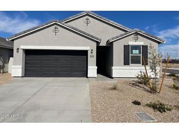 One-story house with a two-car garage and desert landscaping at 470 W Freedom St, Florence, AZ 85132