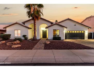 Charming single-story home with a well-manicured yard and inviting curb appeal at sunset at 6809 E Gelding Dr, Scottsdale, AZ 85254