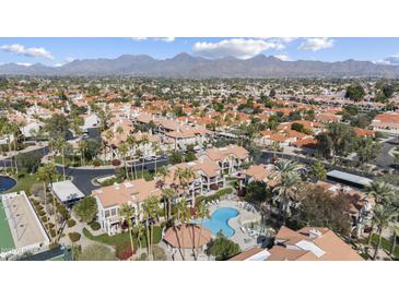 Panoramic aerial view of a community featuring lush landscaping, a pool, and stunning mountain views at 9705 E Mountain View Rd # 1050, Scottsdale, AZ 85258