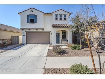 Two-story house with a brown garage door and landscaped yard at 13184 N 144Th Ln, Surprise, AZ 85379