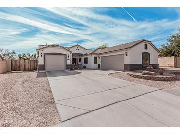 Charming single-Gathering home featuring a three-car garage, well-maintained landscaping, and a welcoming facade at 17347 W Statler St, Surprise, AZ 85388