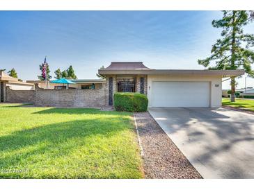 Ranch style home with attached garage and well-manicured lawn at 17449 N 106Th Ave, Sun City, AZ 85373