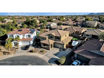 Aerial view of two story house with pool, basketball court and landscaped yard at 18651 E Superstition Dr, Queen Creek, AZ 85142