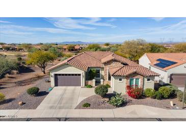 Single-story home with desert landscaping, two-car garage, and mountain views at 20642 N 268Th Dr, Buckeye, AZ 85396