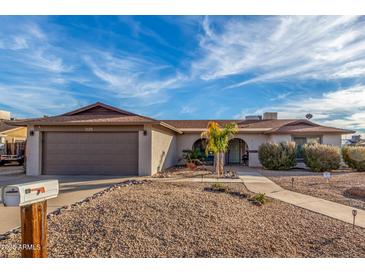 Single-story home with a two-car garage and desert landscaping at 3125 W Waltann Ln, Phoenix, AZ 85053