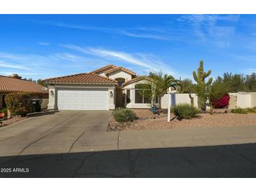 Charming single-story home with a well-manicured desert landscape and a spacious two-car garage at 7390 E Hanover Way, Scottsdale, AZ 85255