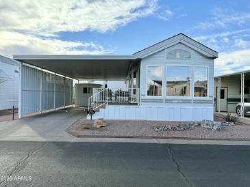 Single-wide manufactured home with carport and covered porch at 7750 E Broadway Rd # 860, Mesa, AZ 85208