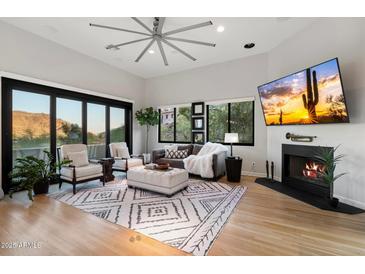 Bright living room with hardwood floors, fireplace, and mountain views at 8150 N 47Th St, Paradise Valley, AZ 85253