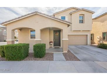 Inviting two-story home with neutral tones, landscaped front, covered entry, and attached two car garage at 8535 E Olla Ave, Mesa, AZ 85212