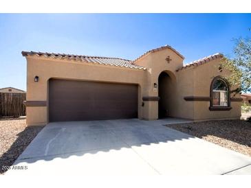 Tan house with brown garage door and arched entryway at 1203 E Judi St, Casa Grande, AZ 85122