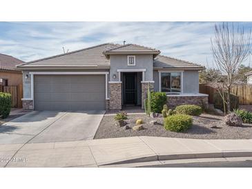 One-story home with gray exterior, stone accents, and landscaped front yard at 21370 N 260Th Ln, Buckeye, AZ 85396