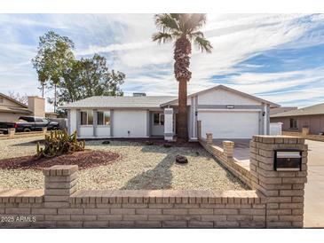 Single-story house with a two-car garage and desert landscaping at 3513 W Danbury Dr, Glendale, AZ 85308