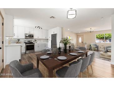 Modern dining room featuring wood flooring, an elegant table setting and a spacious design at 5313 W Osborn Rd, Phoenix, AZ 85031