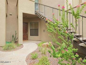 Inviting walkway leads to the unit with desert landscaping and private stairs to the second floor at 7027 N Scottsdale Rd # 150, Paradise Valley, AZ 85253