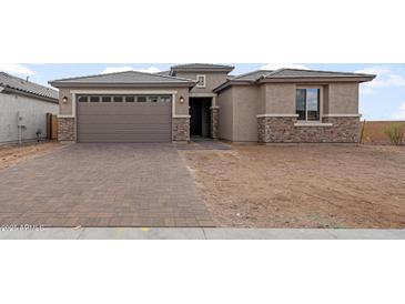 One-story home with a two-car garage and a brick facade at 7163 W Oberlin Way, Peoria, AZ 85383