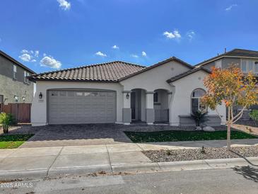 Single-story home with gray garage door and landscaping at 15787 W Mariposa Grande --, Surprise, AZ 85387