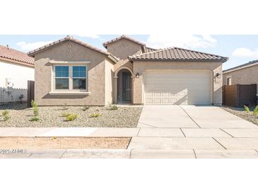 Single-story home with a tile roof, two-car garage, and low-maintenance front yard at 18169 E Bronco Dr, Queen Creek, AZ 85142