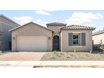 Charming single-story home with a two-car garage, desert landscaping, and a stylish front door at 18180 E Tiffany Dr, Queen Creek, AZ 85142