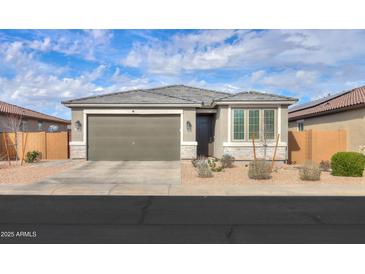 Charming single-story home featuring a two-car garage and desert landscaping at 346 E Tahiti E Dr, Casa Grande, AZ 85122
