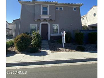 Two-story house with gray siding, dark brown door, and landscaping at 1180 E Marlin Dr, Chandler, AZ 85286