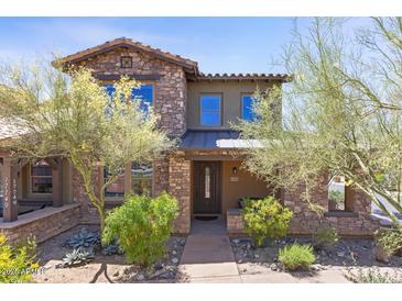 Charming two-story home with stone accents, desert landscaping, and inviting front entrance at 17763 N 93Rd Way, Scottsdale, AZ 85255